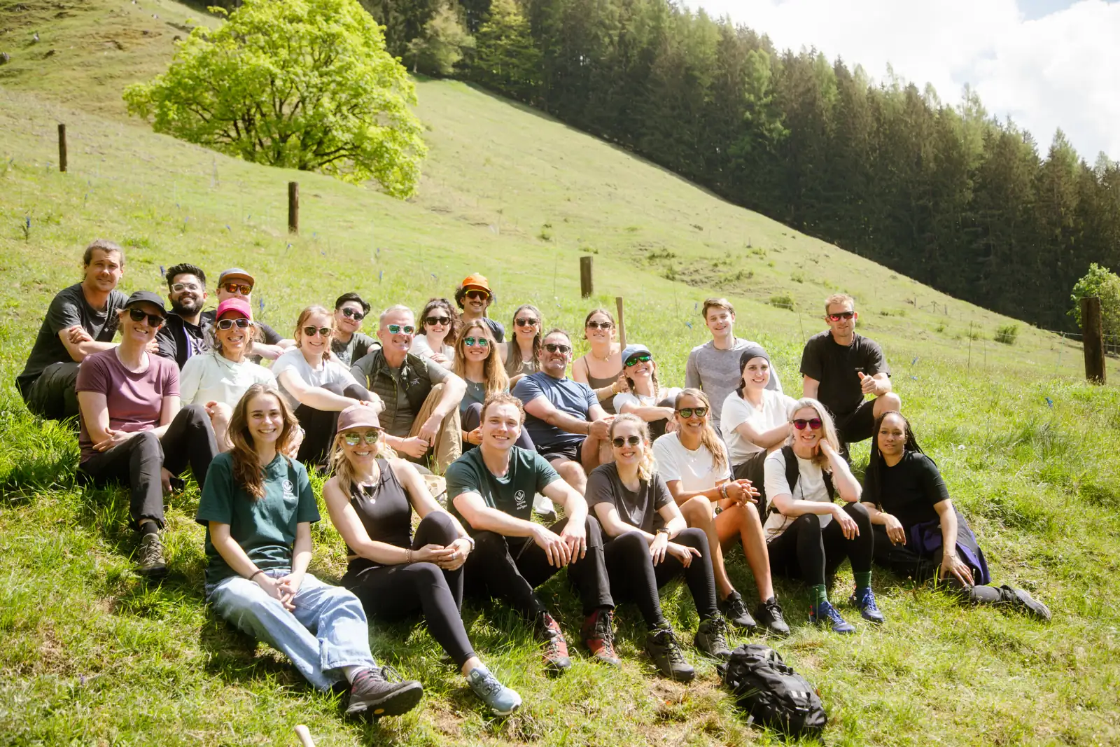 Group sitting on the meadow after the planting